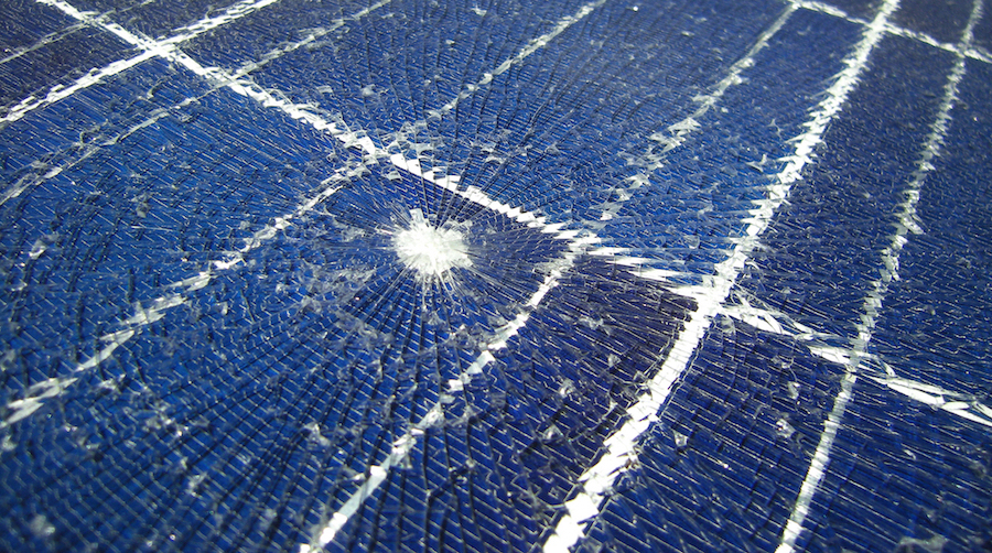 shattered solar panel with crack due to falling object